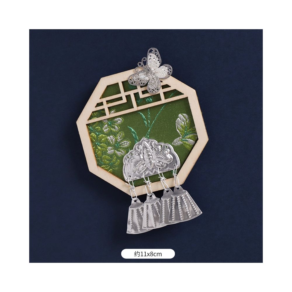 Green scenic refrigerator magnet with metal tassels.