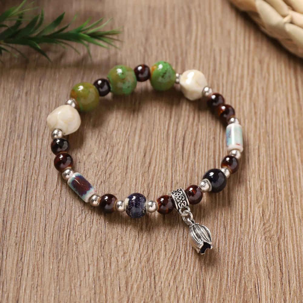Green and white patterned beads with black accents, unique texture.