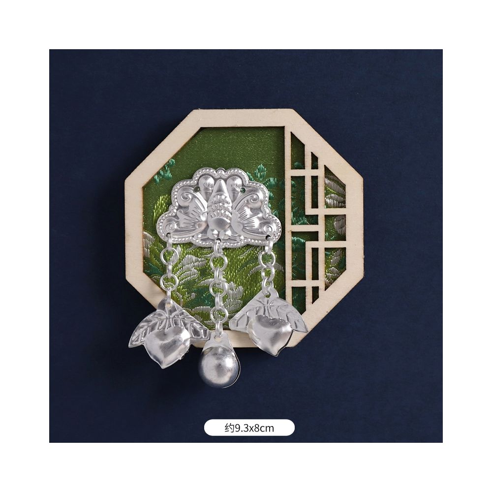 Green window-style decorative magnet with metal charms