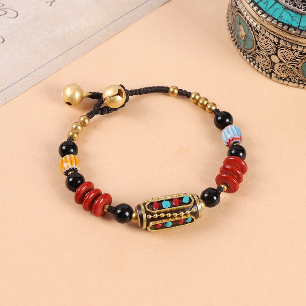 Close-up highlights turquoise and red beads, fine craft details.