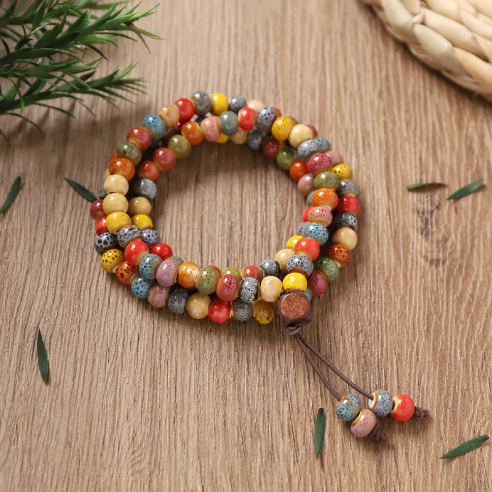 Colorful glazed ceramic beads, multi-loop design with tassel, rich ethnic charm.