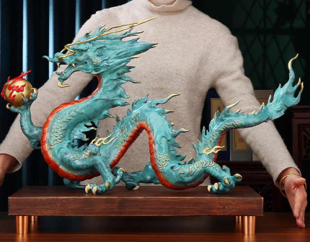 Colorful Chinese dragon statue with a red pearl, a Feng Shui symbol of good fortune and strength, displayed on a wooden base as elegant home decor against a dark background 01