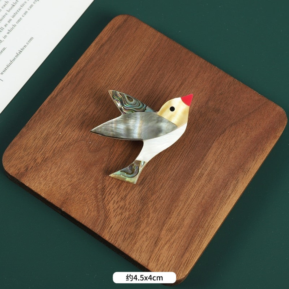 This elegant butterfly brooch is handcrafted from natural mother-of-pearl and iridescent abalone shell, showcasing unique organic patterns. A perfect nature-inspired accessory to elevate any outfit 04