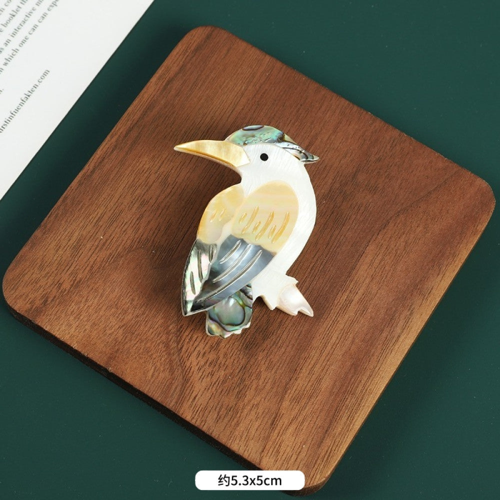 This elegant butterfly brooch is handcrafted from natural mother-of-pearl and iridescent abalone shell, showcasing unique organic patterns. A perfect nature-inspired accessory to elevate any outfit 06