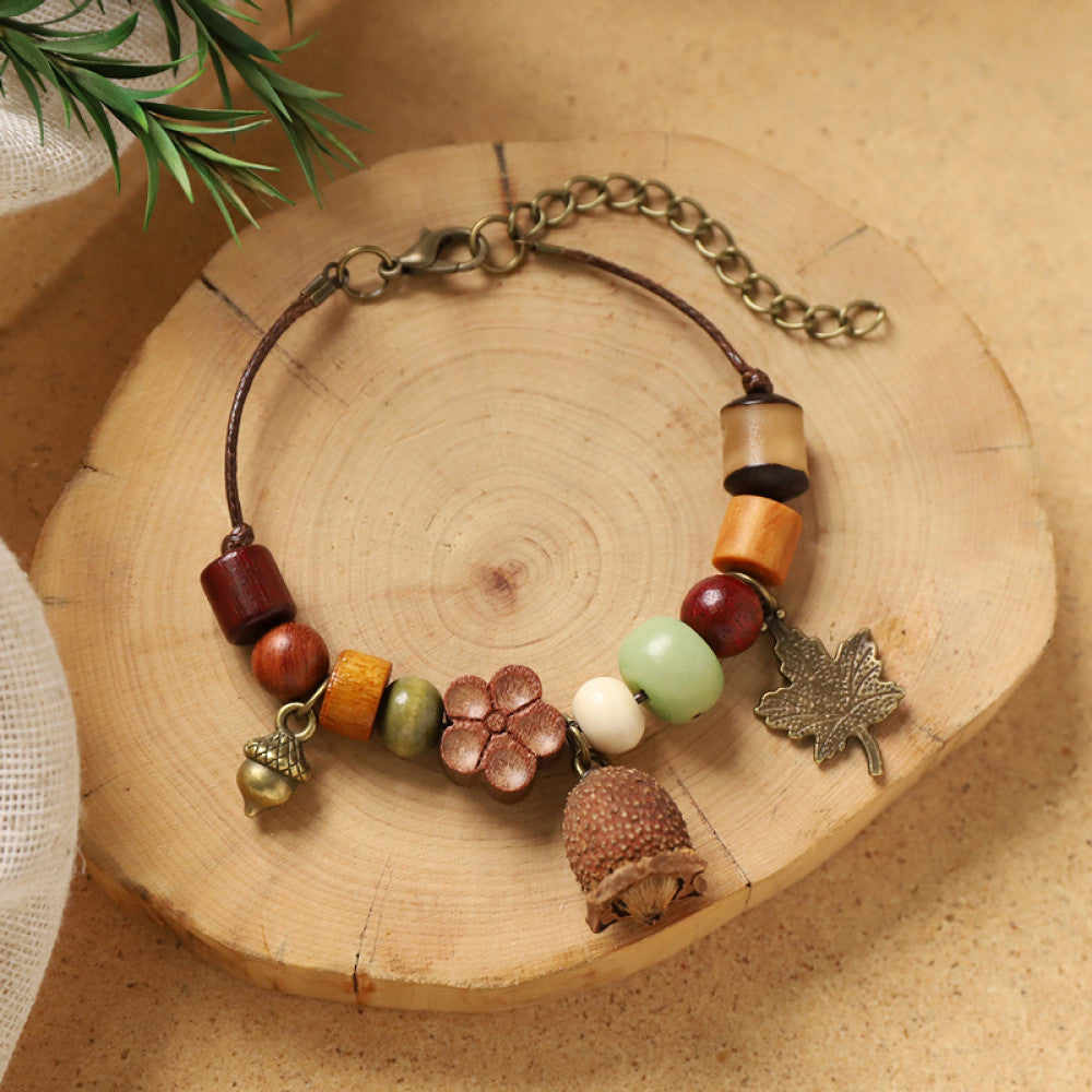 Earthy beads with a pine cone pendant, cozy woodland vibe.