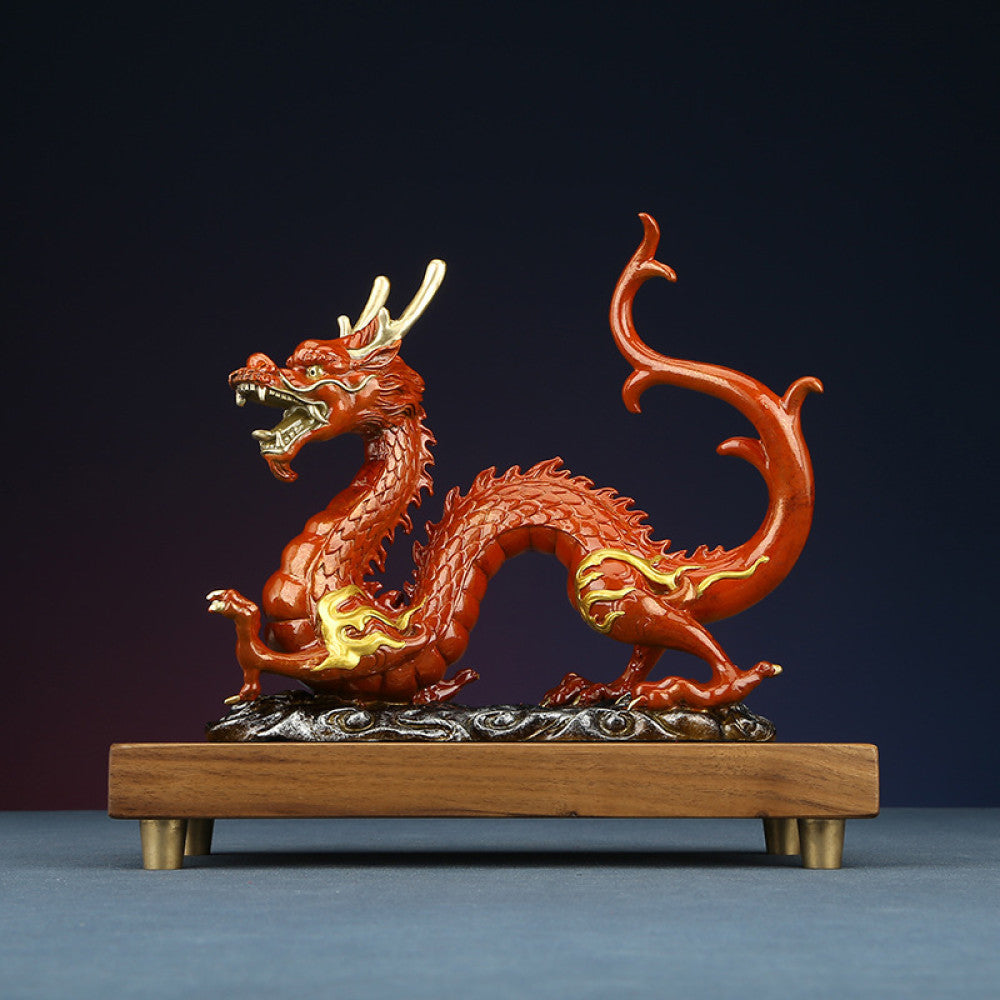 Red Chinese dragon statue with golden accents, a Feng Shui symbol of good fortune and strength, displayed on a wooden base as elegant home decor against a dark background