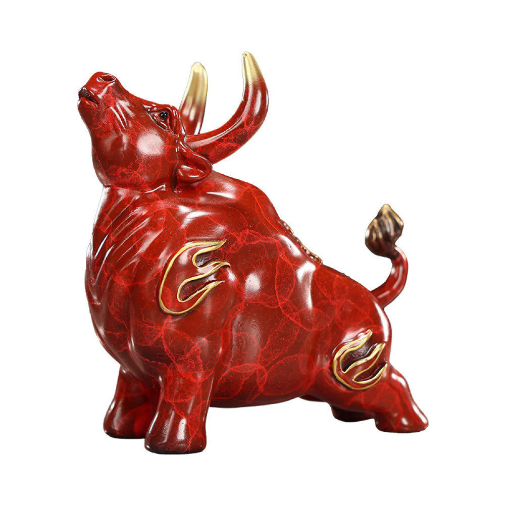 Red bull statue with golden accents and intricate details, a Feng Shui symbol of strength and good fortune, displayed on a polished surface against a green background 03