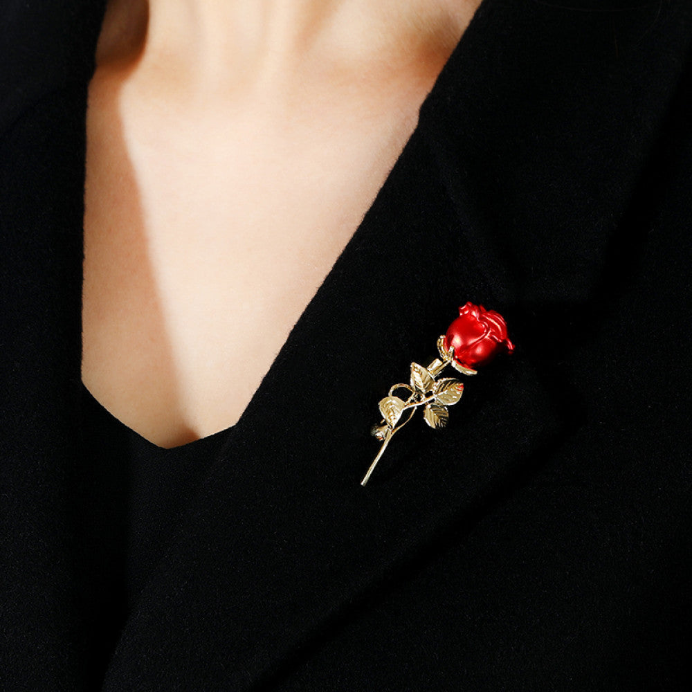 This elegant brooch features vibrant red petals with a lustrous pearl center, set on a gold stem with sparkling crystal accents. A romantic, eye-catching accessory 04