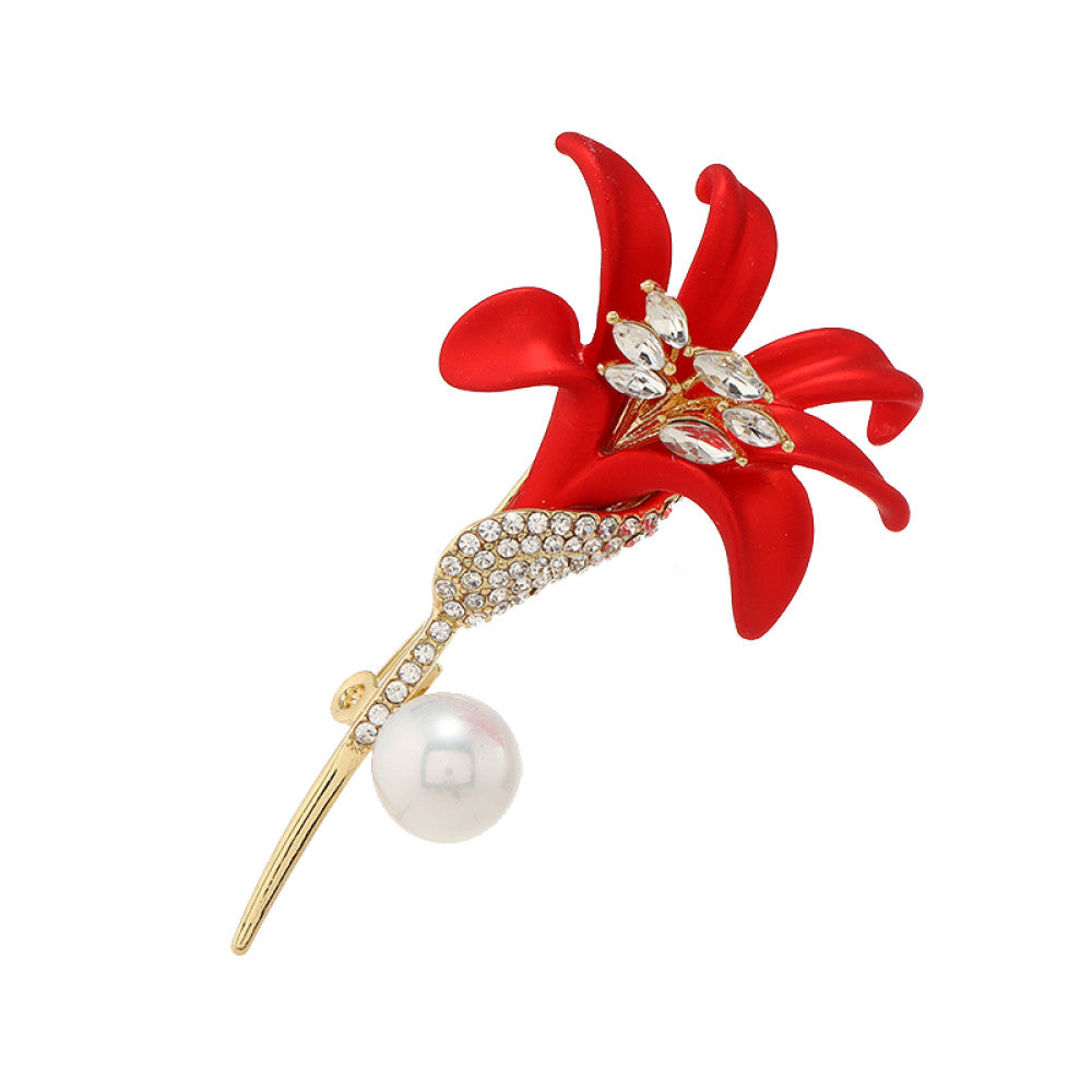 This elegant brooch features a vibrant red lily with a crystal-encrusted gold stem, accented by a lustrous pearl. A sophisticated floral accessory for any outfit 06