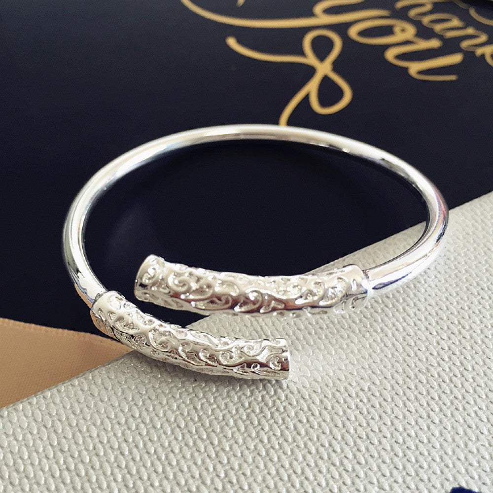 Rose gold plated bangle with engraved detail, displayed on textured surface, ideal for luxury fashion and minimalist jewelry enthusiasts 02