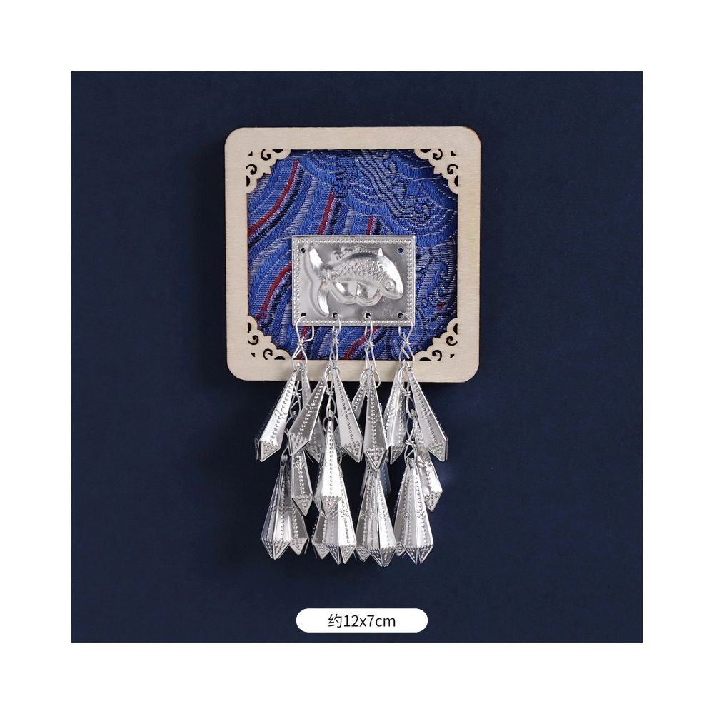 Light blue circular magnet with silver tassels.
