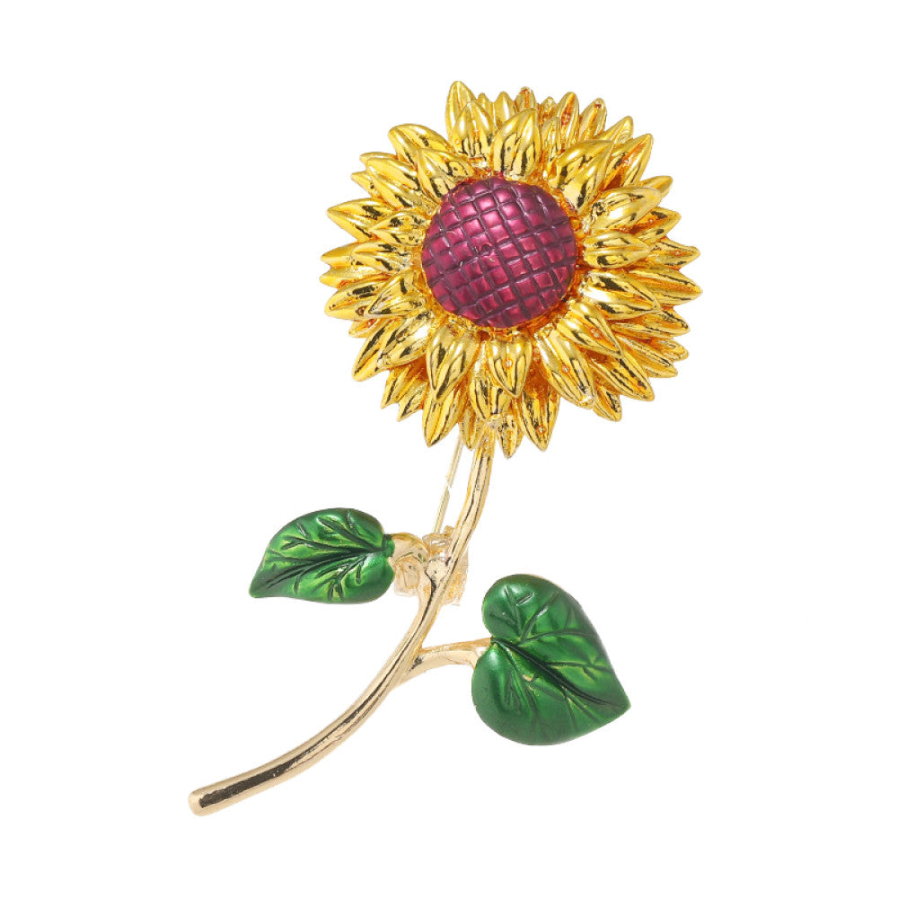 This charming brooch captures the warmth of a sunflower, with intricately detailed gold petals radiating from a rich purple center. Delicate green enamel leaves add a touch of natural vibrancy, while the slender gold stem completes the lifelike design. Perfect for adding a cheerful, nature-inspired touch to blazers, scarves, or everyday outfits, this piece blends whimsical charm with timeless elegance 04