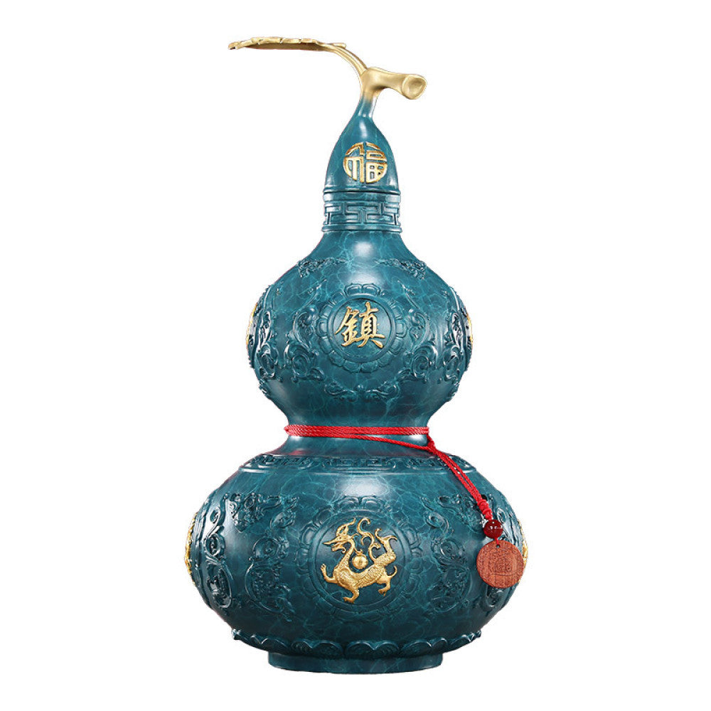 Blue-green brass gourd feng shui decor with golden dragon, "Fu" (fortune) characters, and red string, isolated on white background