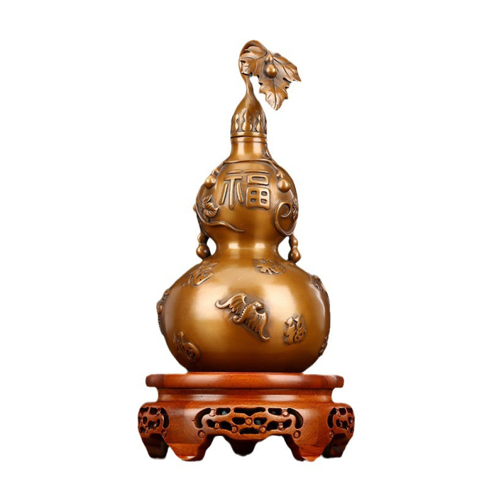 Traditional Chinese brass gourd decor with fortune characters and intricate carvings, placed on a wooden base against a teal curtain background 06