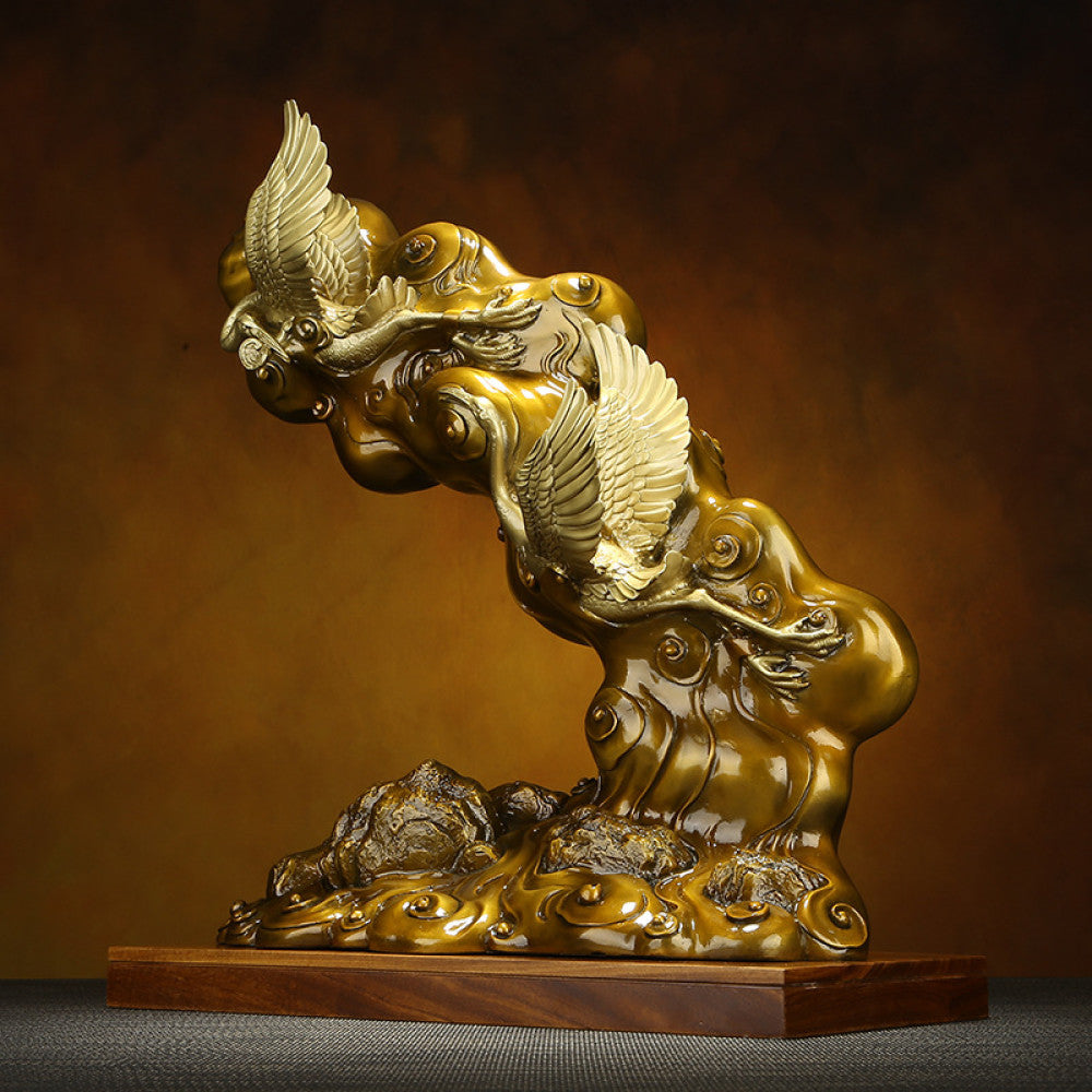 Traditional Chinese bronze sculpture of two cranes with clouds, placed on a wooden base against a warm brown background