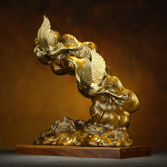 Traditional Chinese bronze sculpture of two cranes with clouds, placed on a wooden base against a warm brown background