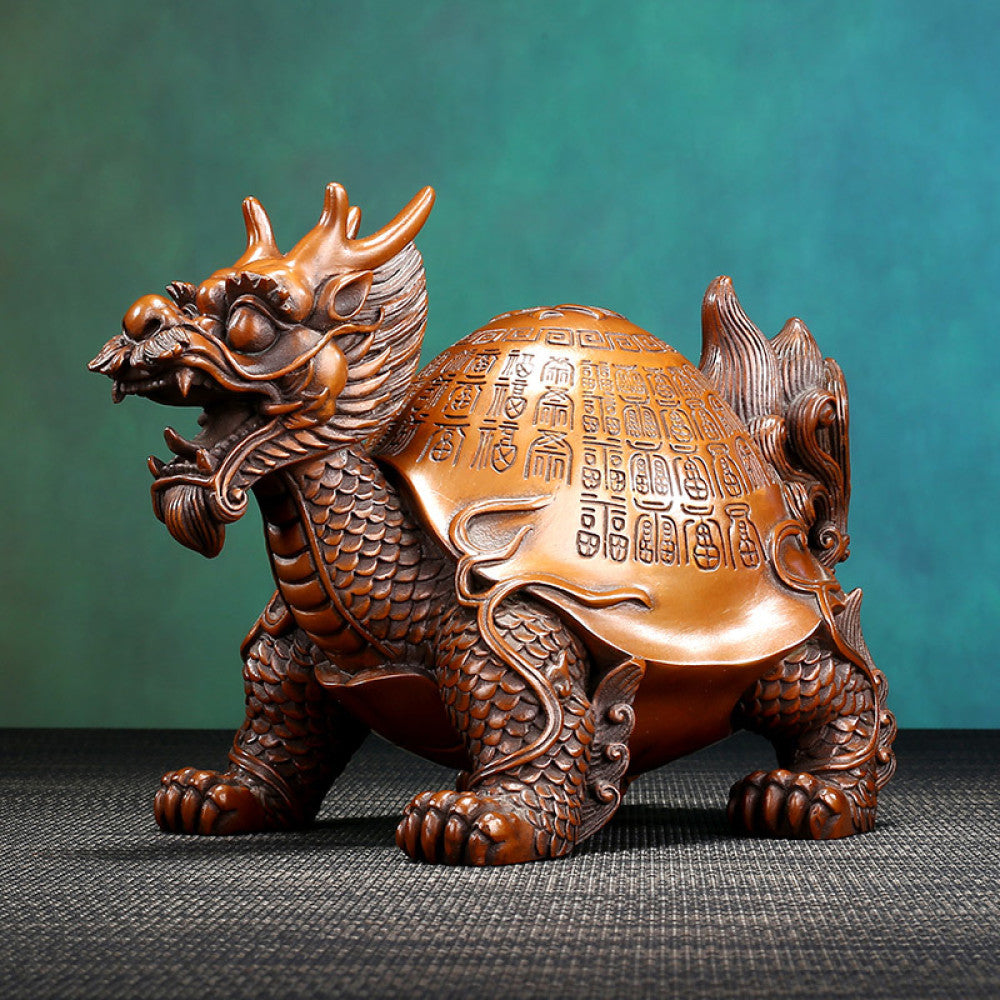 Traditional Chinese bronze dragon turtle statue with intricate inscriptions on its shell, displayed against a teal gradient background