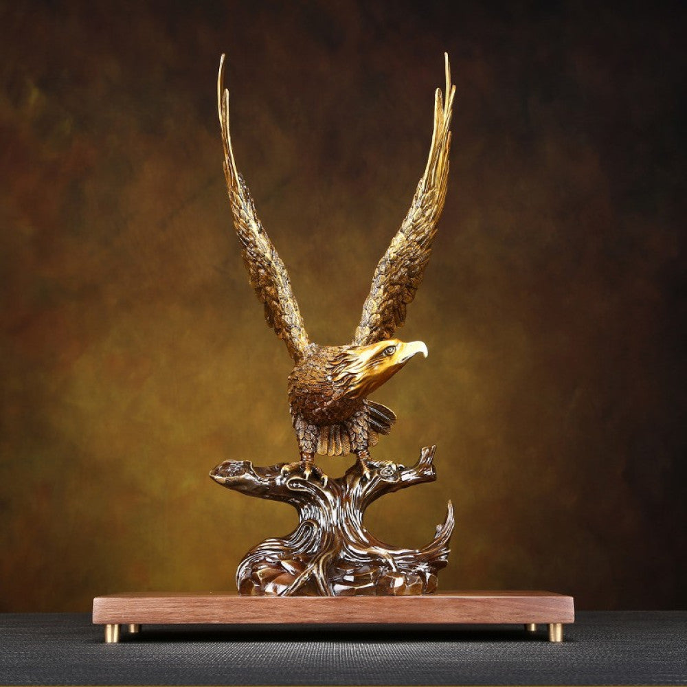 Traditional Chinese bronze eagle statue with spreading wings, perched on a branch - shaped base with a wooden platform, set against a warm brown background