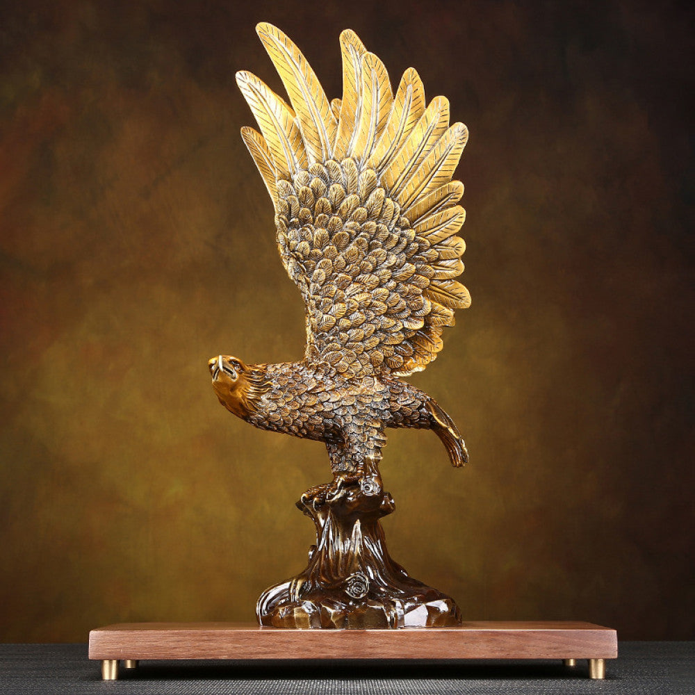 Traditional Chinese bronze eagle statue with spreading wings, perched on a branch - shaped base with a wooden platform, set against a warm brown background 02