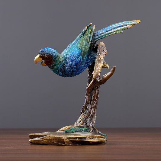 Colorful traditional Chinese parrot statue with blue and green hues, perched on a branch - shaped base, set against a gray background
