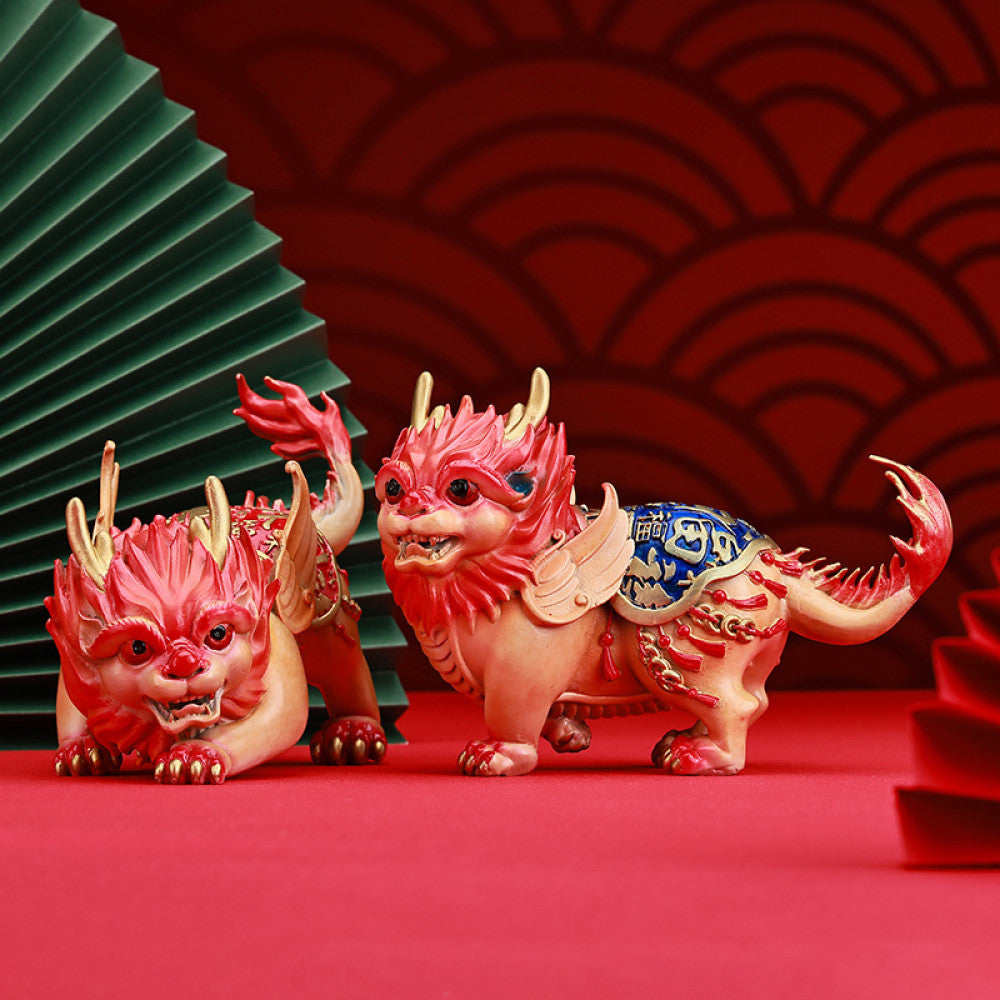 Pair of colorful traditional Chinese Qilin statues with red and blue - golden details, placed against a red background with Chinese fan decoration