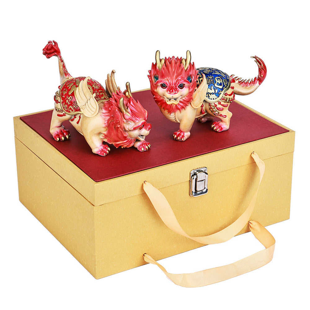 Pair of colorful traditional Chinese Qilin statues with red and blue - golden details, placed against a red background with Chinese fan decoration 05