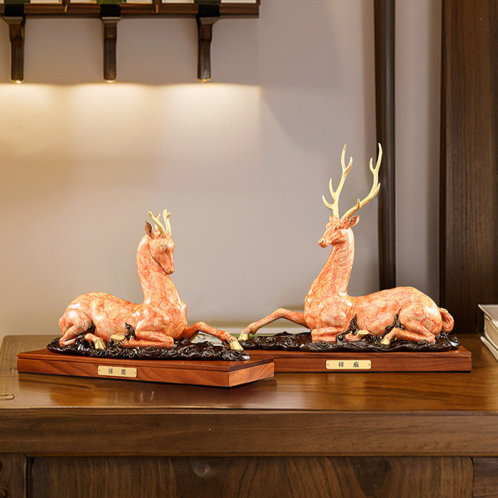 Traditional Chinese golden bronze deer statue in a reclining pose with detailed antlers, placed on a wooden base against a dark green background with traditional books 01