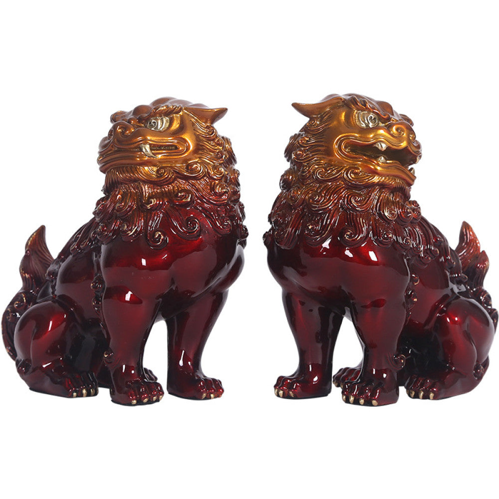 Pair of traditional Chinese red and gold Foo Dog statues with intricate details, set against a white background