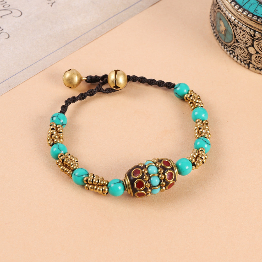 Woven black cord with turquoise and red beads, vintage tribal charm.