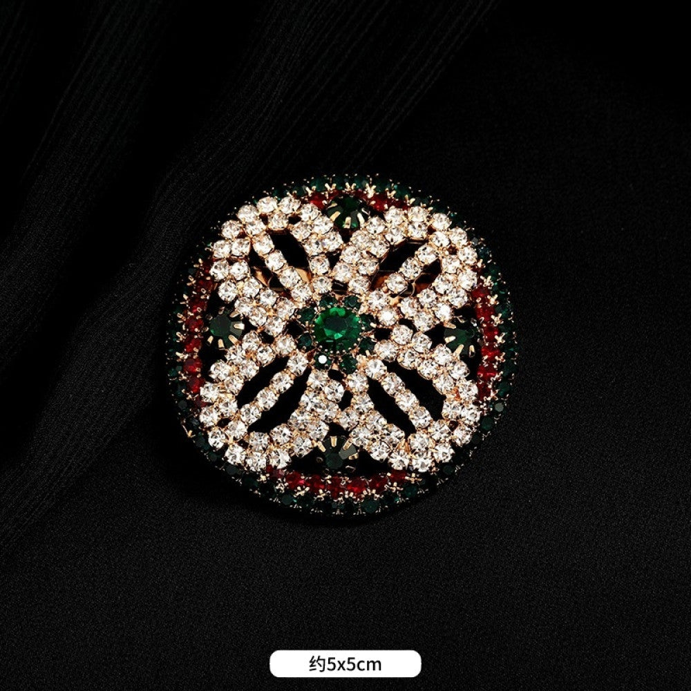This ornate multi-layer floral brooch features vibrant red and green gemstones set in a clear crystal frame, adding a touch of vintage glamour to any outfit. Measures approx. 5x5cm 02