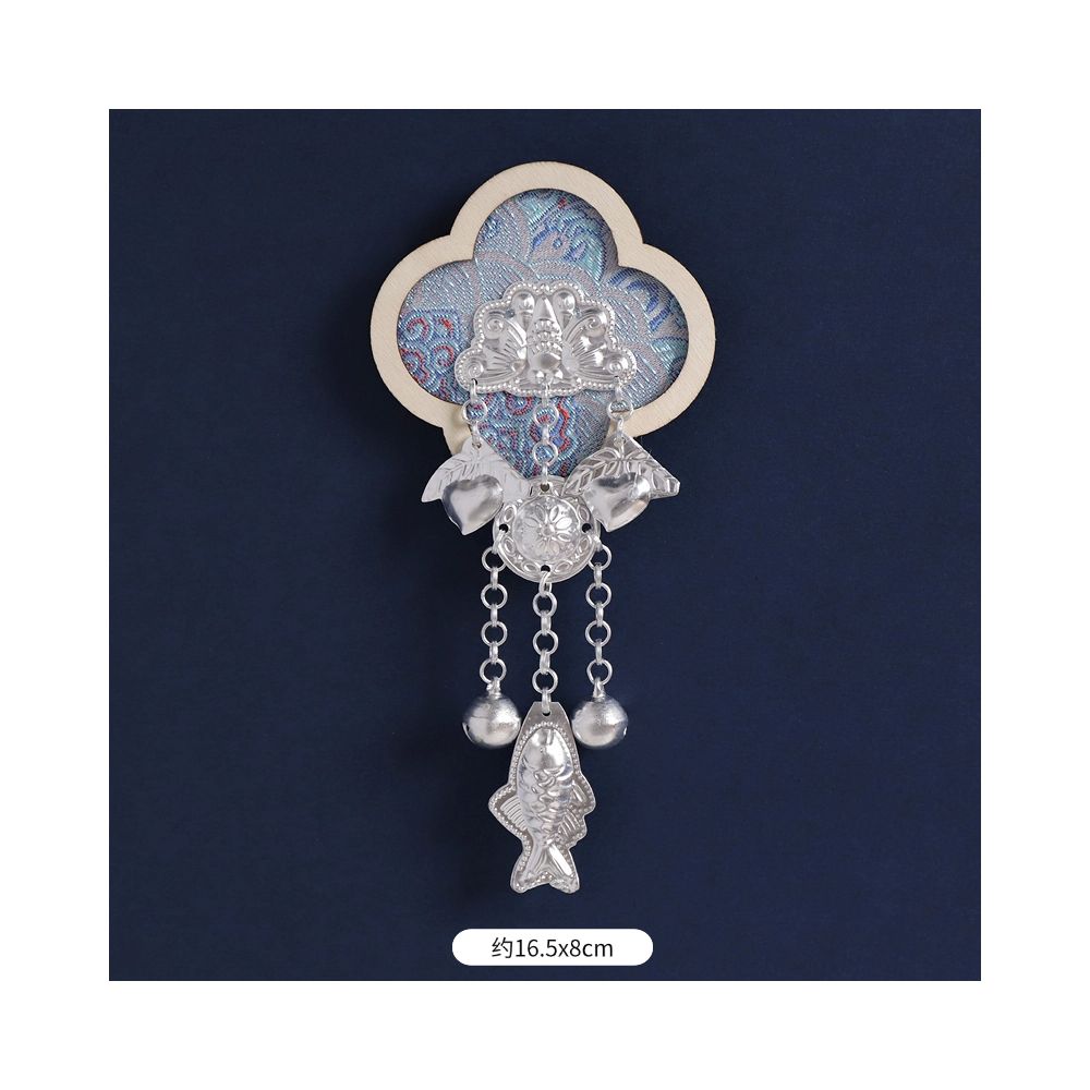 White and blue fridge magnet with long tassels.
