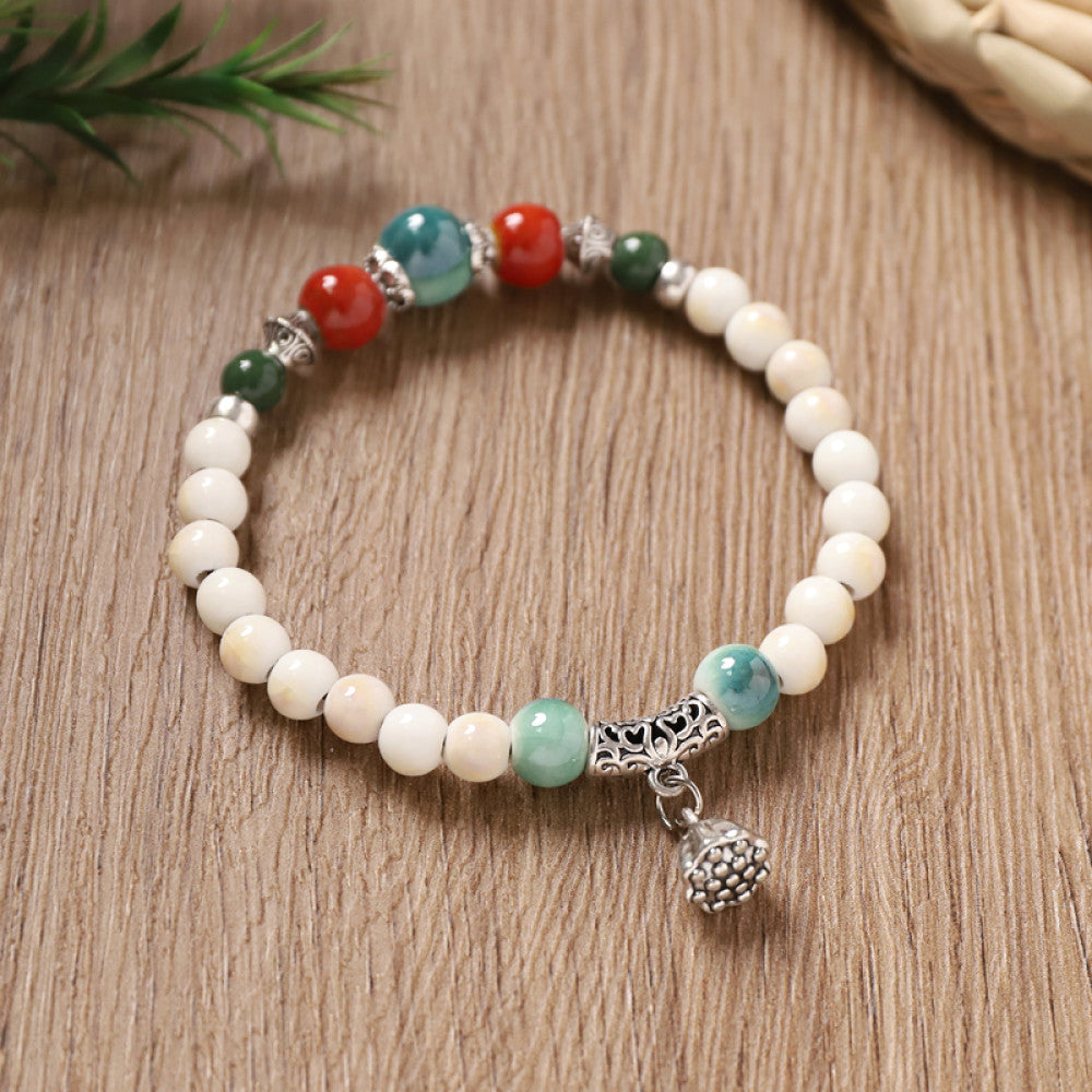 White beads with turquoise accents, clean and elegant.