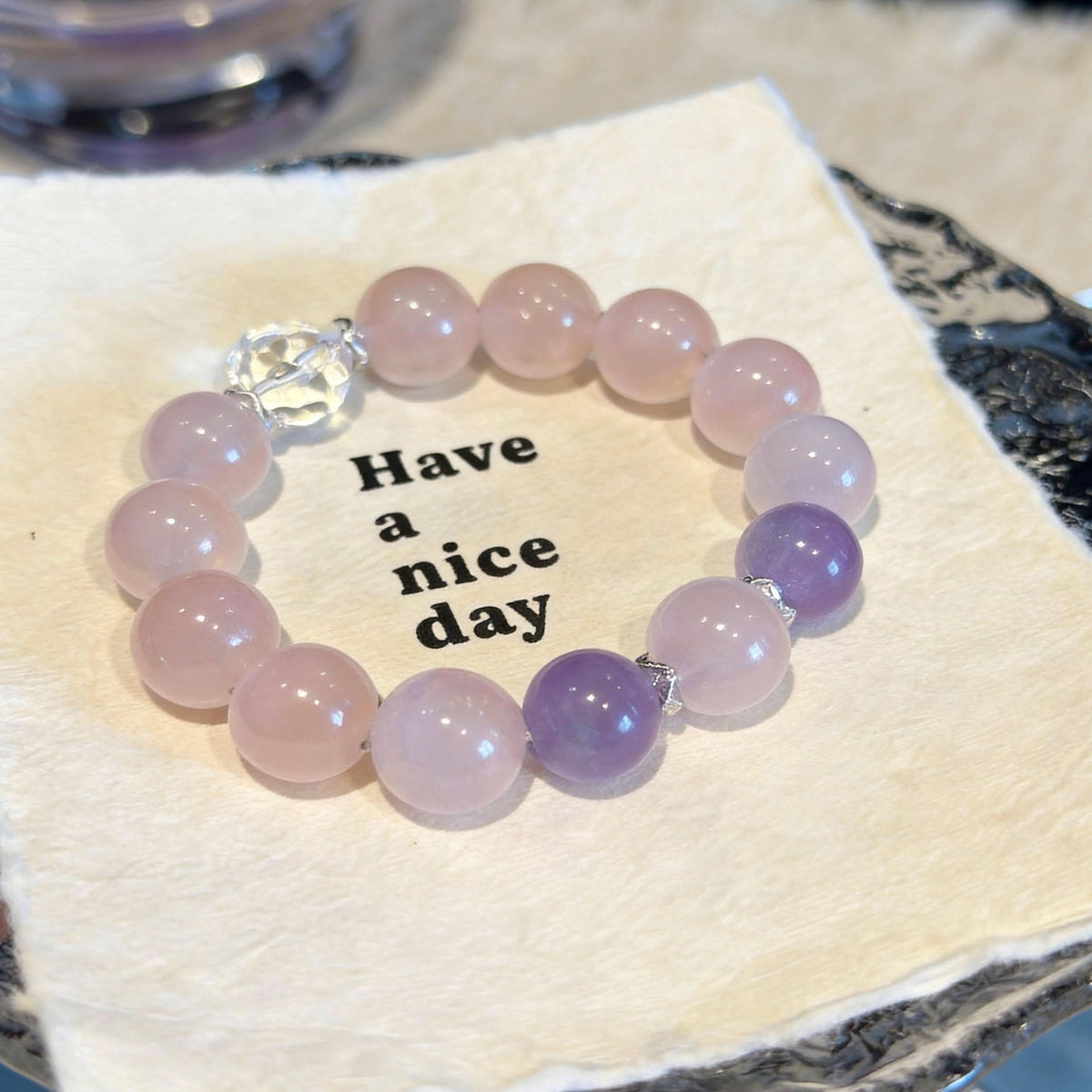 Pink‑amethyst human bead bracelet displayed on vintage fabric tray | DIY Jade