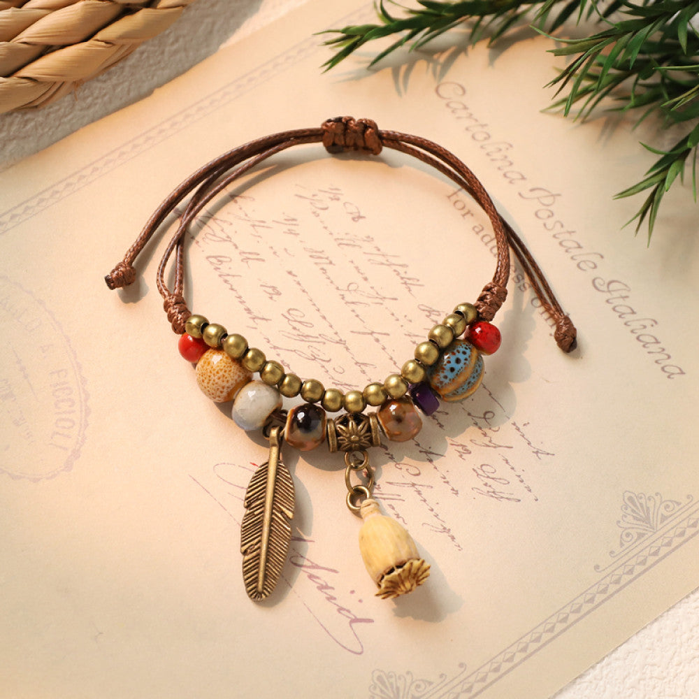 Adjustable bracelet with beige bell charm and feather | DIY Jade
