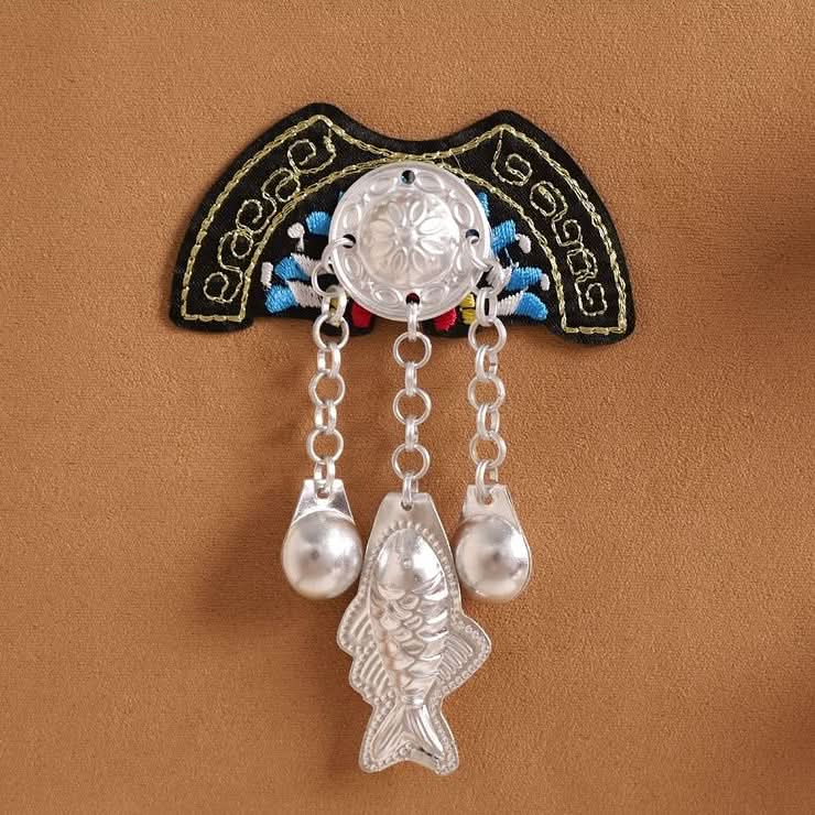 Black border embroidered applique, Miao‑style silver charms with pearl dangling detail