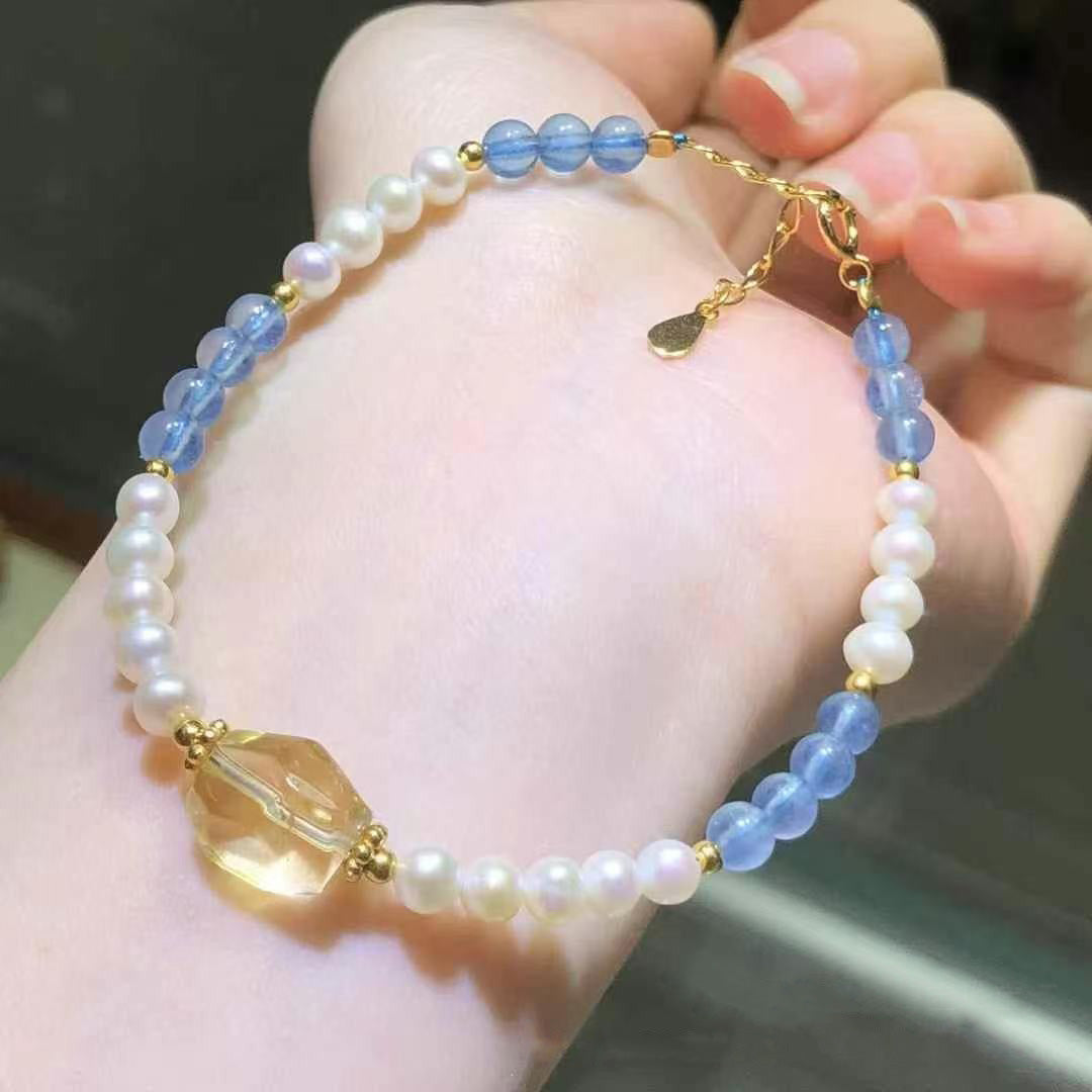 Blue crystal and pearl bracelet with yellow quartz charm, worn on wrist | DIY Jade