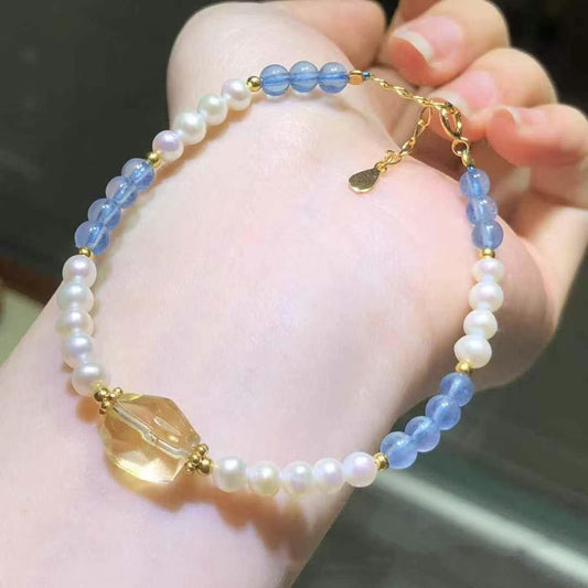 Blue crystal and pearl bracelet with yellow quartz charm, worn on wrist | DIY Jade