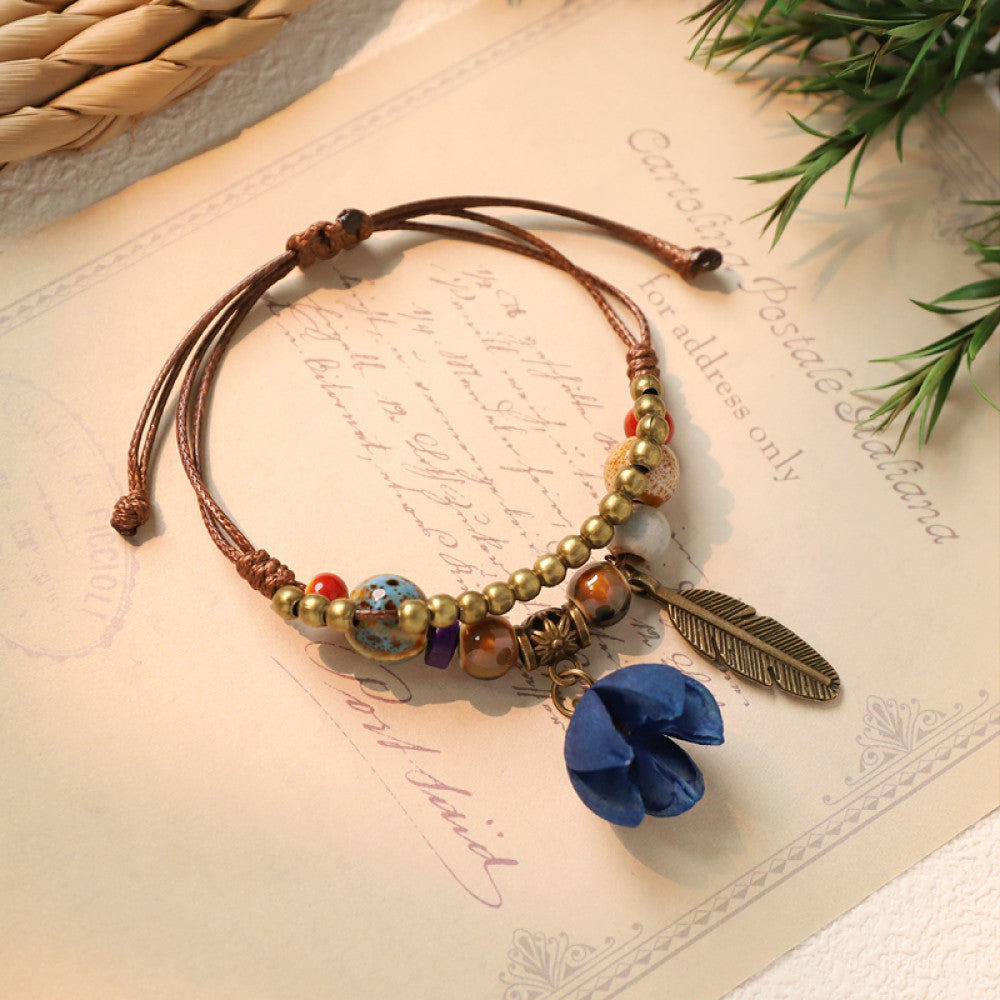 Bohemian bracelet with blue flower charm and feather detail | DIY Jade
