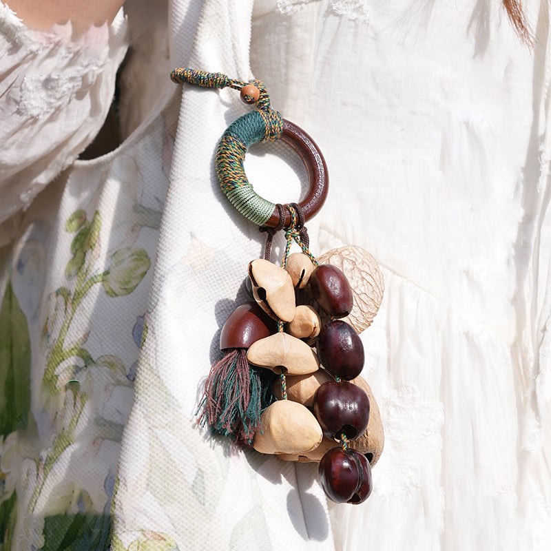 Boho ring seed pod bag charm displayed on linen dress, botanical accessory | DIY Jade