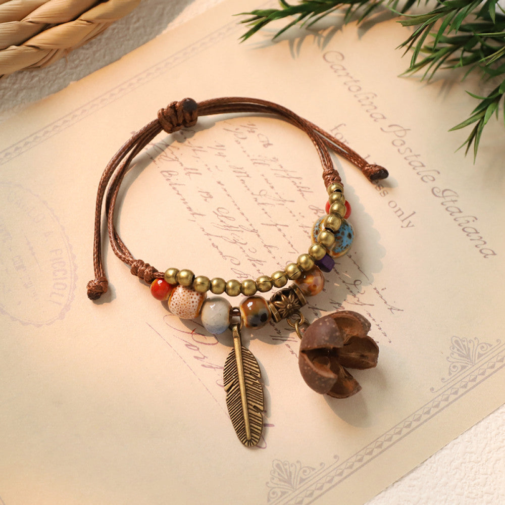 Woven bohemian bracelet with brown acorn charm and feather | DIY Jade
