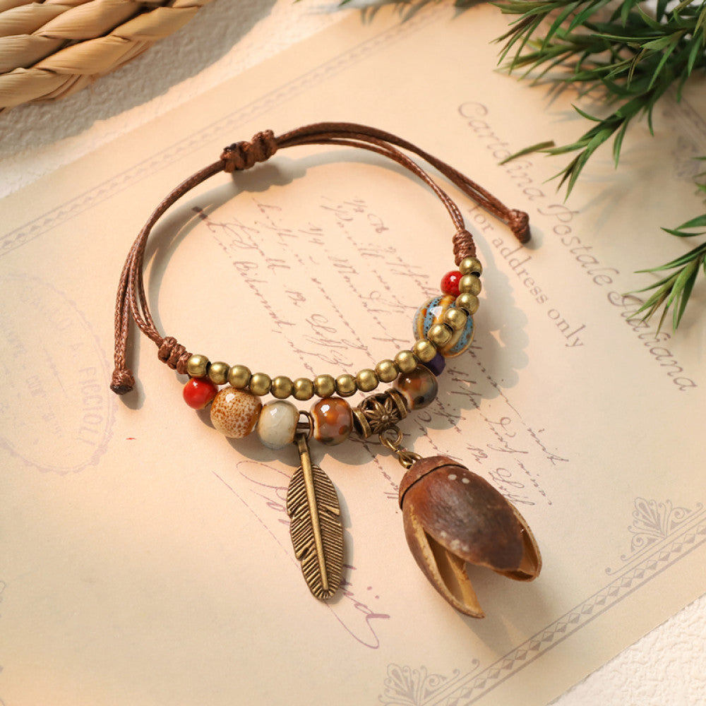 Adjustable bracelet with brown nut charm and feather detail | DIY Jade