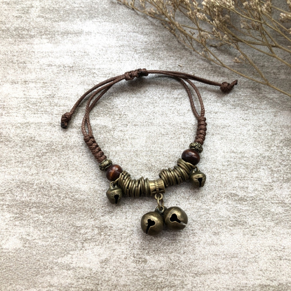 Woven brown bracelet with two bronze bell charms | DIY Jade