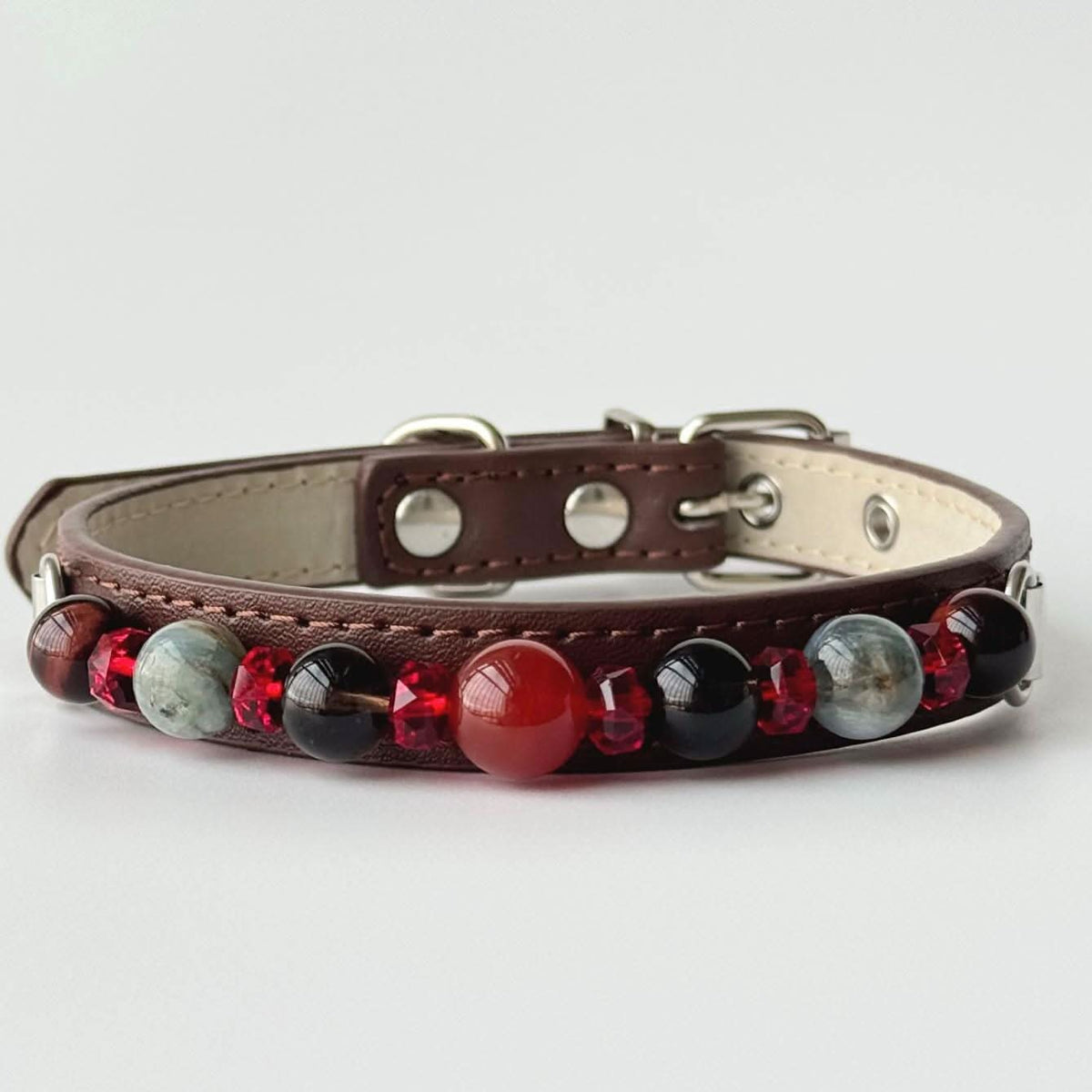 Studio shot brown faux leather pet collar decorated with red, black and grey gem beads | DIY Jade