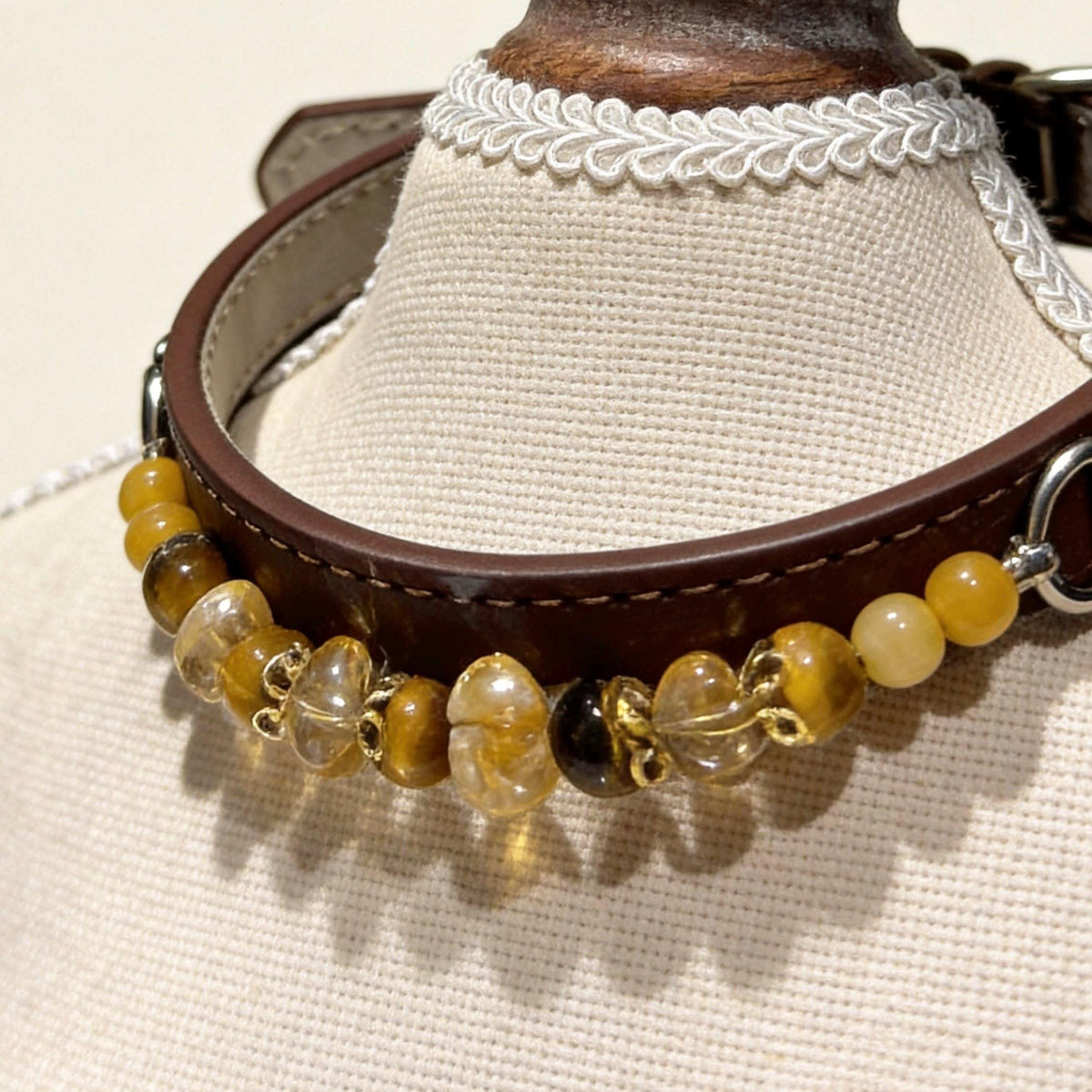 Brown leather pet collar with golden tiger‑eye crystal beads on display bust | DIY Jade