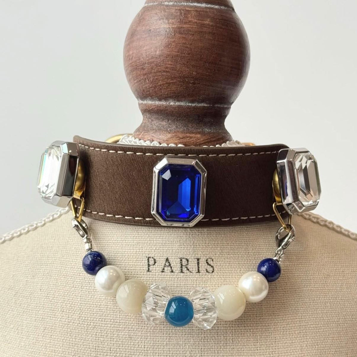 Brown leather pet collar set with large square blue gem, pearl and blue bead chain on display bust | DIY Jade