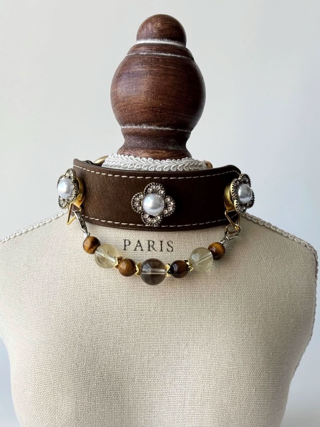 Brown pet collar with clover pearl charms and earth‑tone bead chain on display bust | DIY Jade