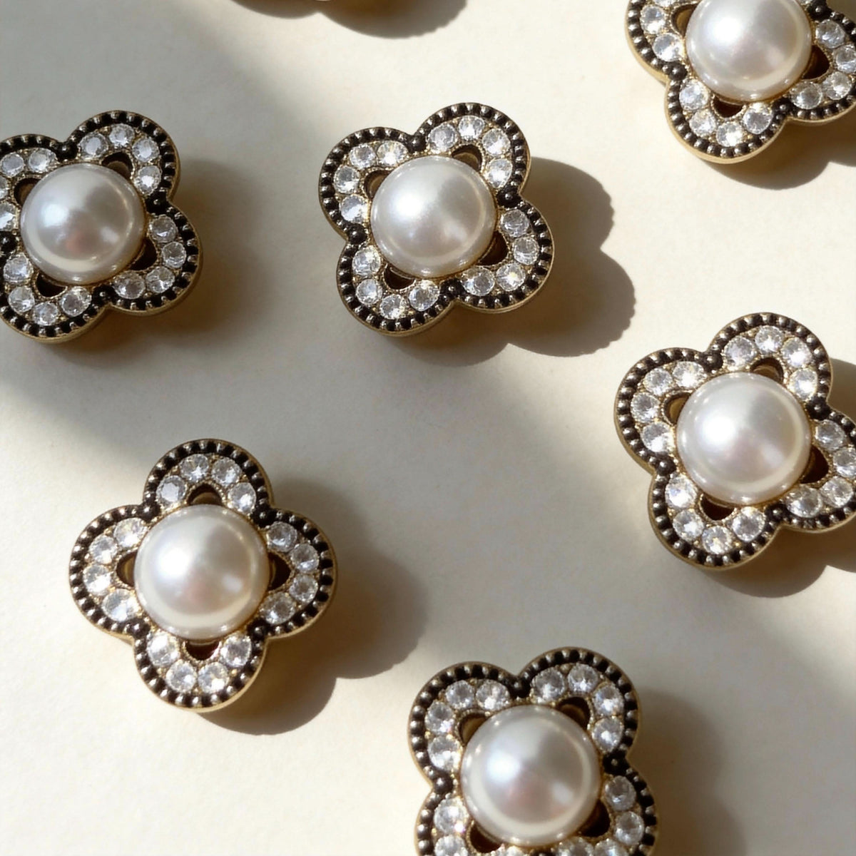 Vintage clover‑shaped pearl rhinestone charms for pet collars flat lay product shot | DIY Jade