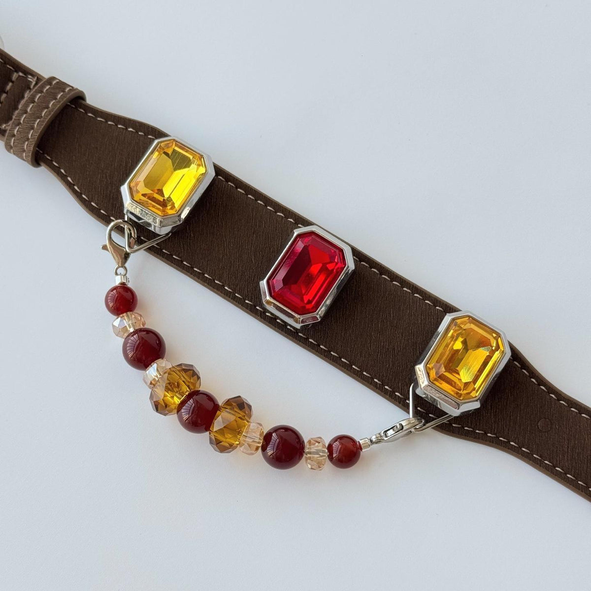 Flat lay of a vintage gemstone pet collar — brown faux leather strap detail|DIYJade