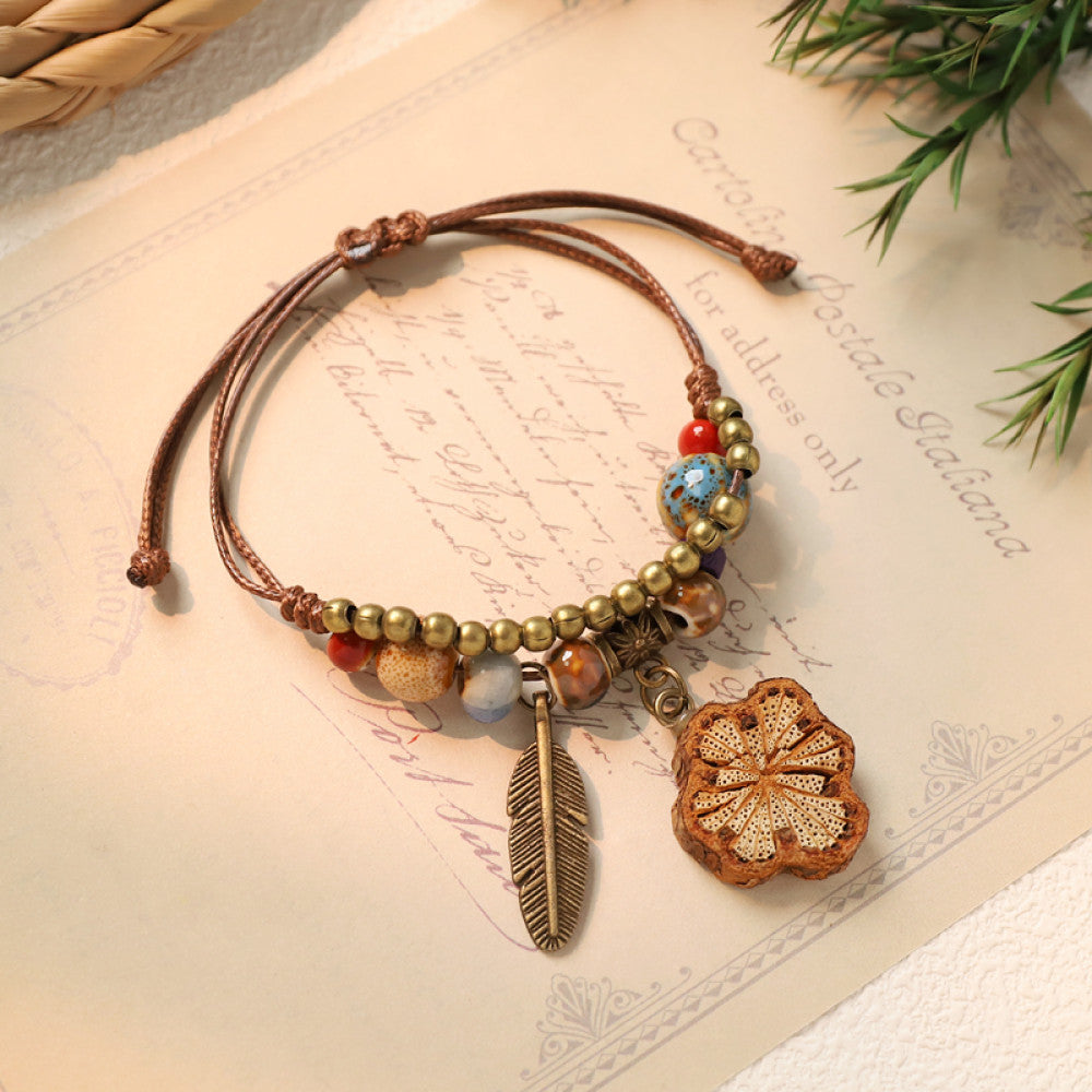 Bohemian woven bracelet with cookie charm and feather detail | DIY Jade