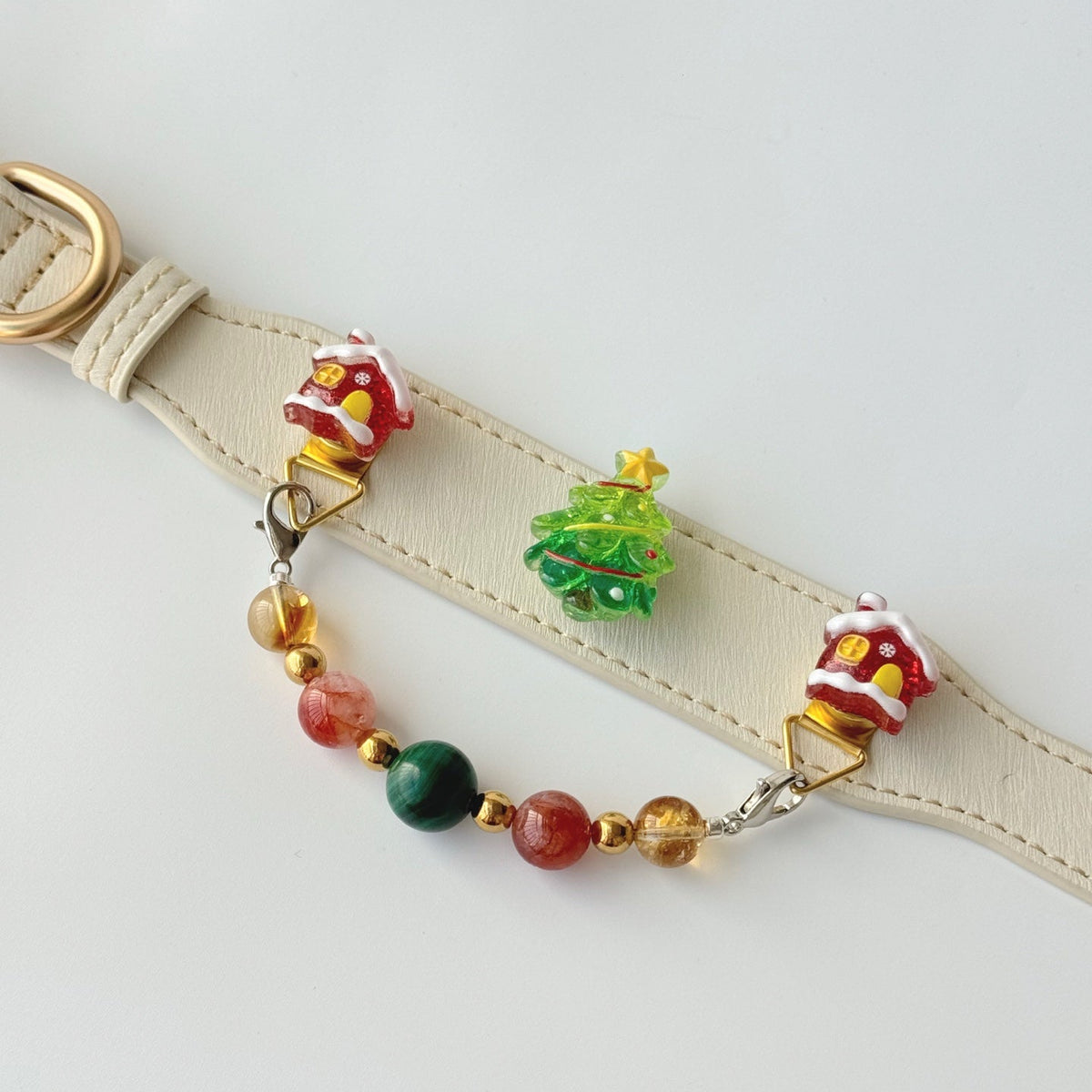 Side lay shot of cream christmas dog collar, detachable malachite citrine gemstone pendant chain with xmas tree house charms | DIY Jade